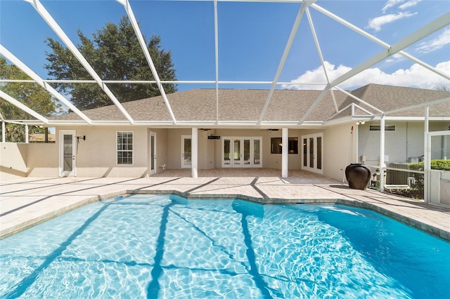 view of swimming pool featuring a lanai, ceiling fan, and a patio