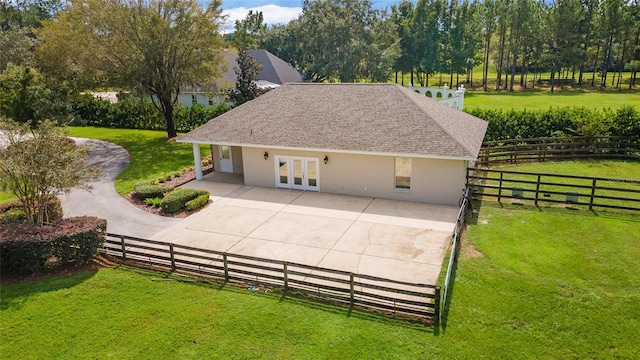 view of home's exterior with french doors, a lawn, and a patio area