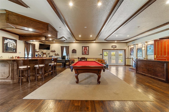 recreation room featuring french doors, dark wood-type flooring, crown molding, pool table, and a textured ceiling