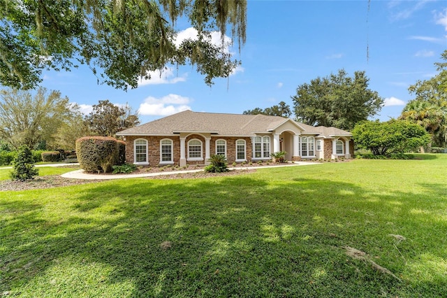 ranch-style home with a front lawn