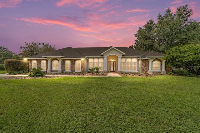 ranch-style house featuring a yard