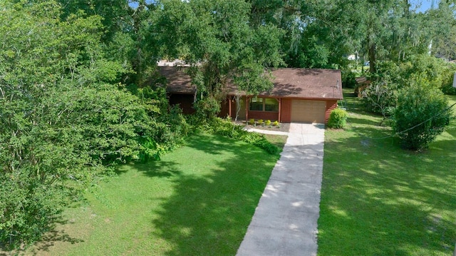 view of front of home with a garage and a front lawn