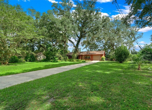 view of front facade with a garage, driveway, and a front lawn