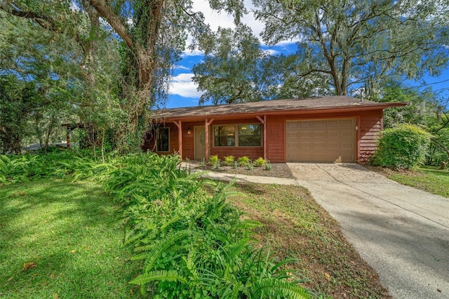 ranch-style house featuring concrete driveway and an attached garage