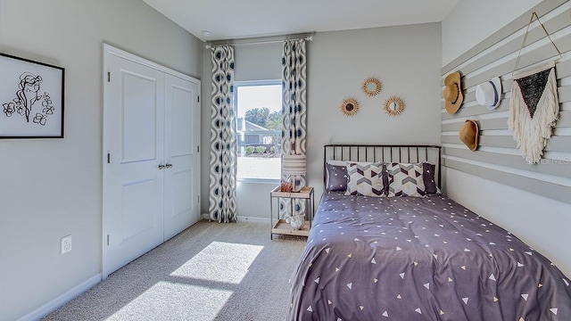 bedroom featuring light colored carpet and a closet