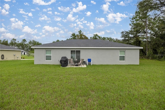 rear view of house featuring a patio and a lawn