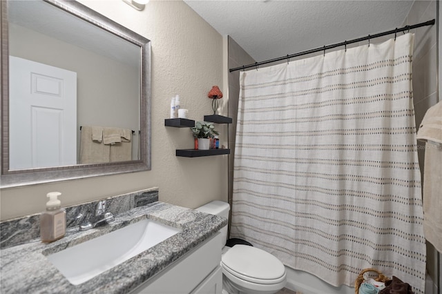 full bathroom with vanity, shower / bath combo, a textured ceiling, and toilet