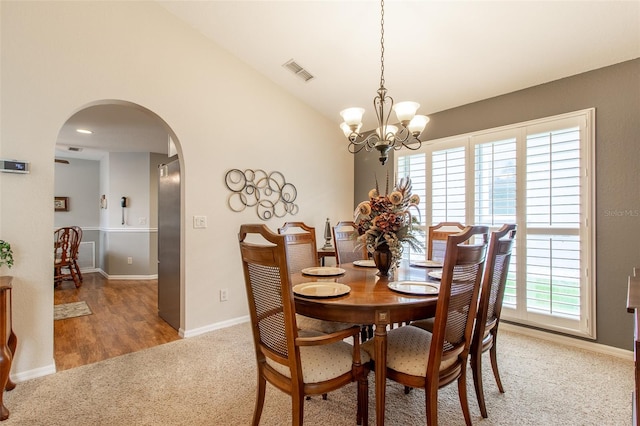 dining room with wood-type flooring, a chandelier, and a healthy amount of sunlight