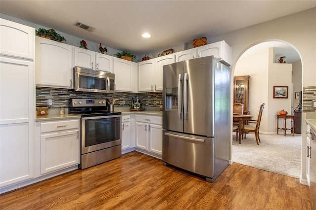 kitchen with white cabinetry, hardwood / wood-style floors, and stainless steel appliances