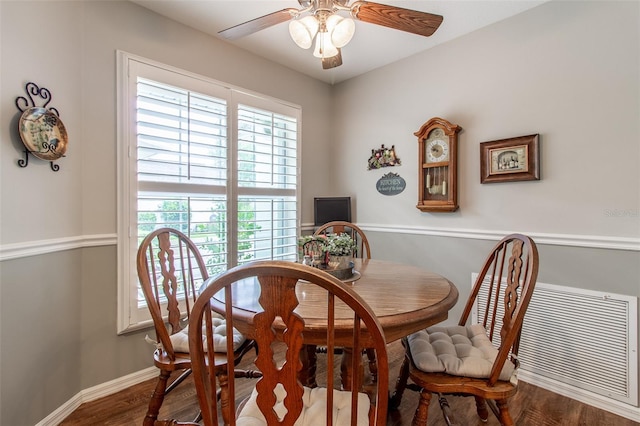 dining area with wood-type flooring and ceiling fan