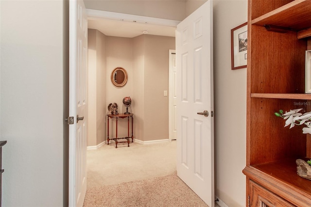 hall featuring light colored carpet