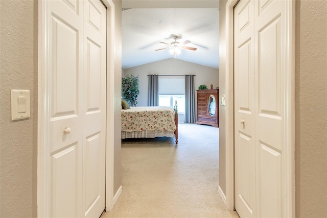 carpeted bedroom featuring ceiling fan and lofted ceiling