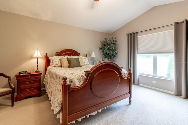 bedroom featuring light carpet, lofted ceiling, and ceiling fan