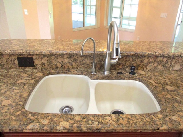 interior details featuring dark stone counters and a sink