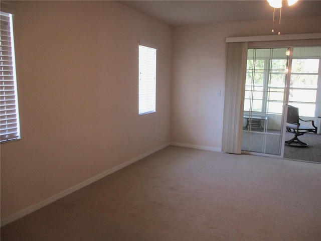 unfurnished room with carpet floors and baseboards