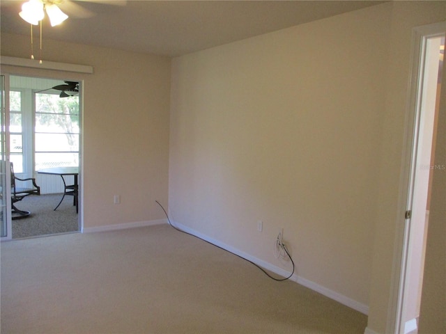 unfurnished room featuring a ceiling fan, baseboards, and carpet flooring