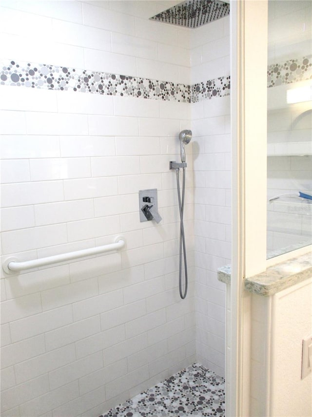 full bath featuring a tile shower