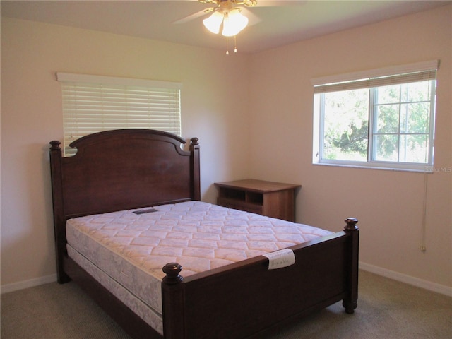 carpeted bedroom featuring baseboards and a ceiling fan