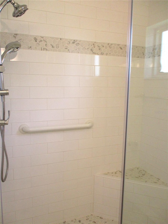 bathroom with a shower stall