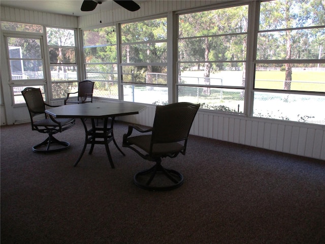 sunroom featuring a ceiling fan