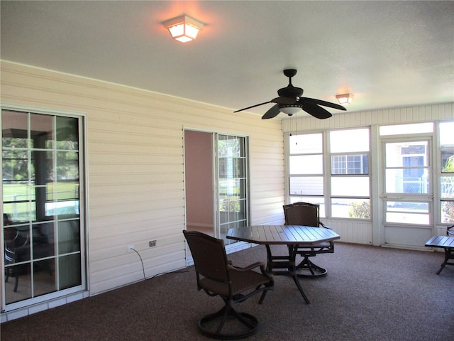 unfurnished sunroom featuring plenty of natural light and a ceiling fan