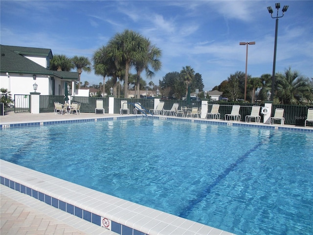 pool with fence and a patio