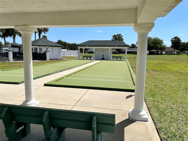 view of property's community featuring a yard and fence