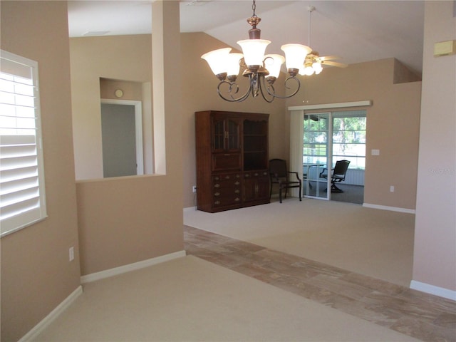 dining space featuring a chandelier, lofted ceiling, and baseboards
