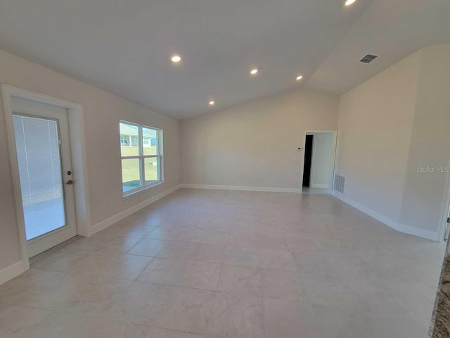 empty room featuring vaulted ceiling