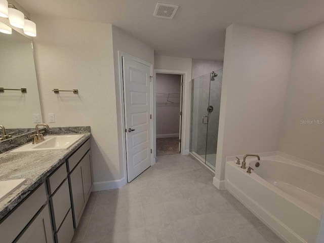 bathroom featuring vanity, tile patterned flooring, and separate shower and tub