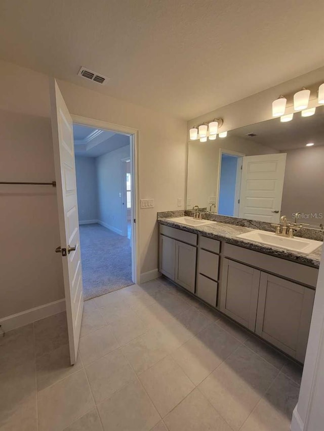 bathroom with tile patterned flooring and vanity