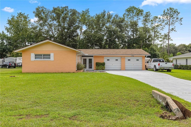 ranch-style house featuring a front lawn and a garage