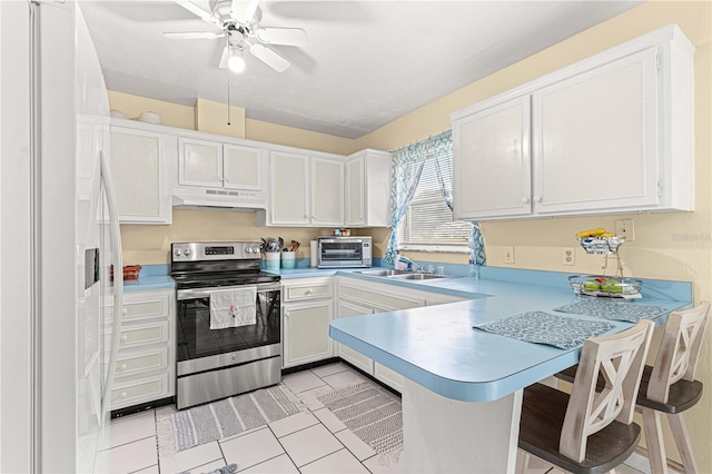 kitchen featuring white cabinets, kitchen peninsula, stainless steel electric range, white refrigerator with ice dispenser, and a kitchen bar