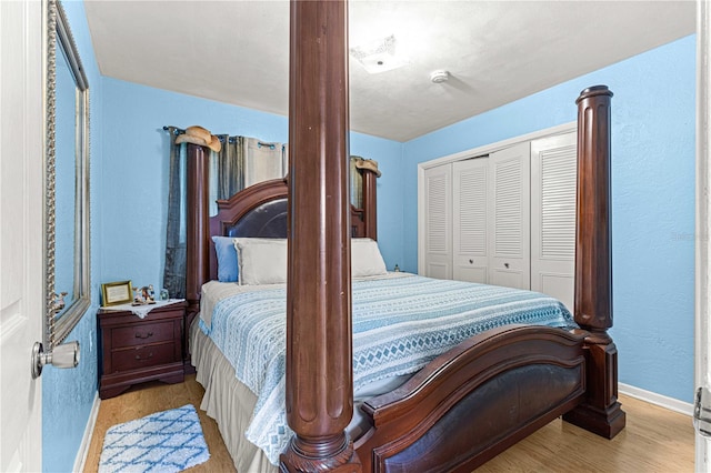 bedroom with a closet and light hardwood / wood-style flooring