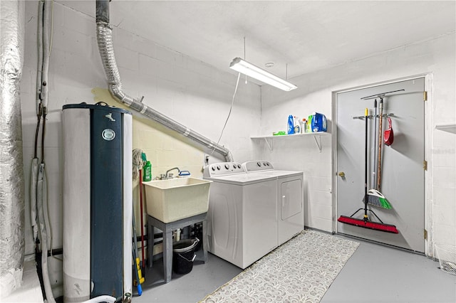 laundry area with independent washer and dryer and sink