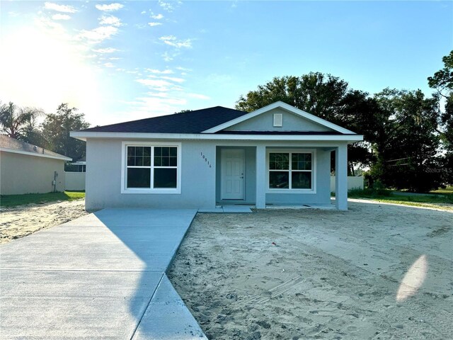 10816 SE 66th Ave, Belleview, FL 34420 - view of front facade with stucco siding and covered porch