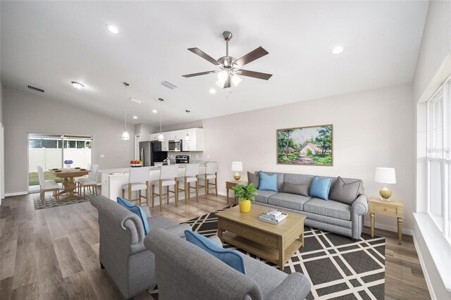 10816 SE 66th Ave, Belleview, FL 34420 - living room featuring visible vents, light wood-style floors, baseboards, recessed lighting, and vaulted ceiling