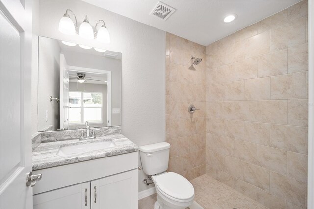 10816 SE 66th Ave, Belleview, FL 34420 - bathroom featuring a ceiling fan, visible vents, vanity, toilet, and tiled shower