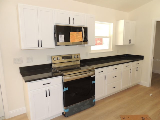 kitchen with light hardwood / wood-style flooring, white cabinetry, and stainless steel appliances