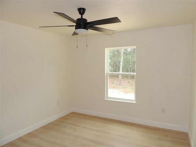 spare room with light wood-type flooring and ceiling fan