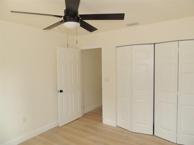 unfurnished bedroom with ceiling fan, a closet, and light hardwood / wood-style flooring