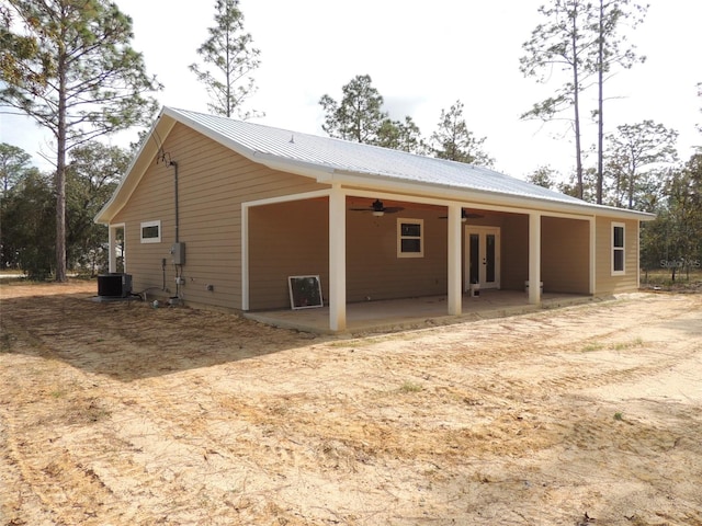 back of property with central air condition unit, ceiling fan, and a patio