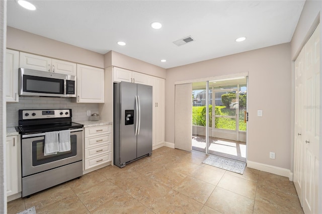 kitchen featuring light stone counters, white cabinetry, stainless steel appliances, and tasteful backsplash