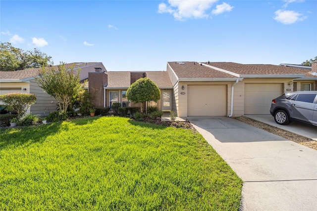 single story home featuring a garage and a front yard