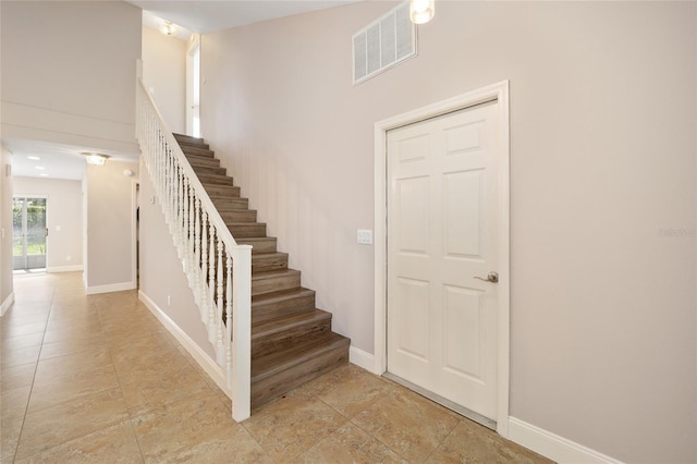 stairs featuring tile patterned flooring