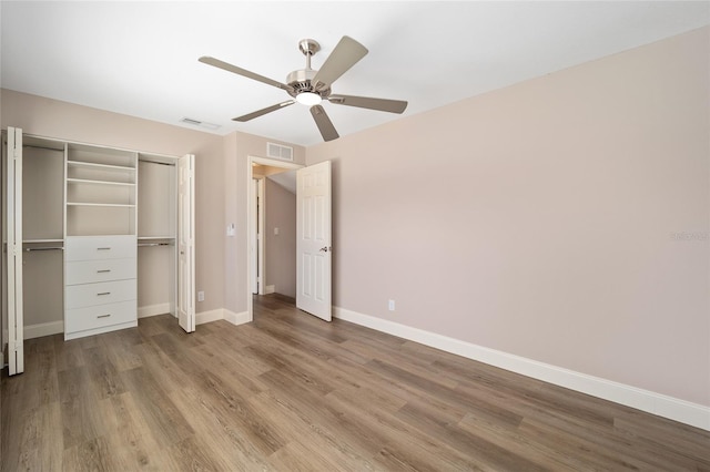 unfurnished bedroom with ceiling fan, a closet, and light hardwood / wood-style flooring