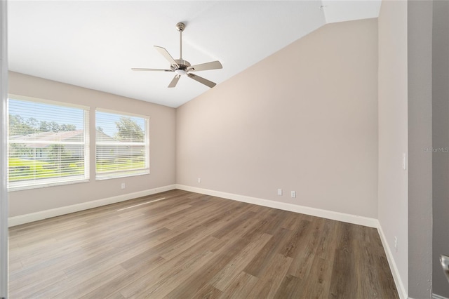 unfurnished room with lofted ceiling, light hardwood / wood-style floors, and ceiling fan