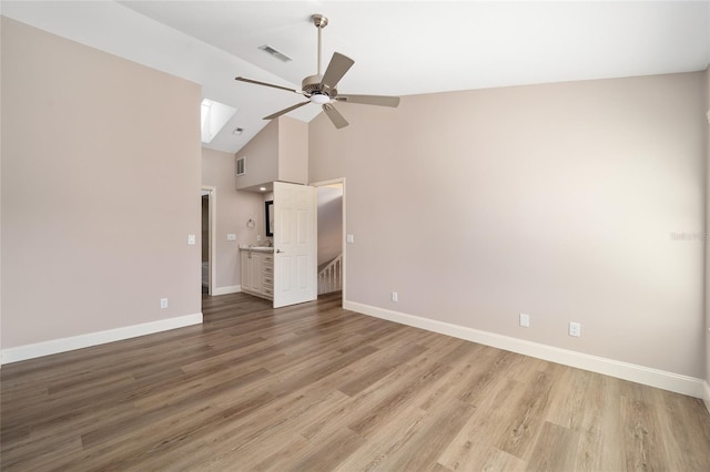 unfurnished bedroom with hardwood / wood-style flooring, high vaulted ceiling, and ceiling fan