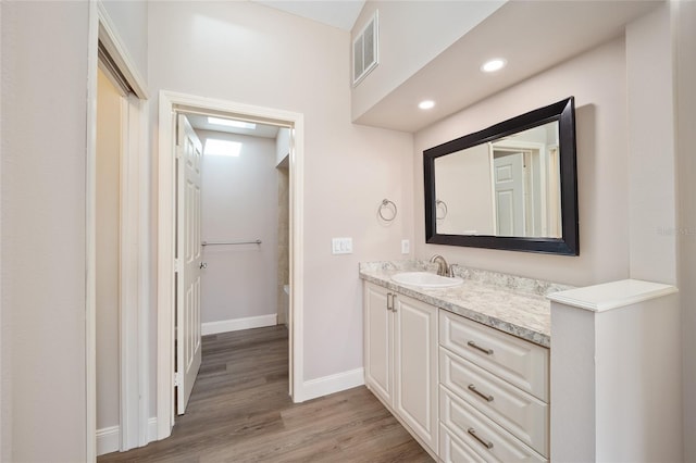 bathroom featuring hardwood / wood-style flooring and vanity