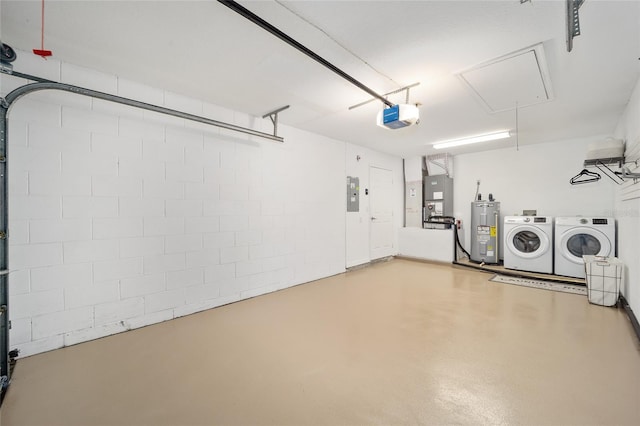 garage featuring a garage door opener, heating unit, electric water heater, electric panel, and washing machine and clothes dryer